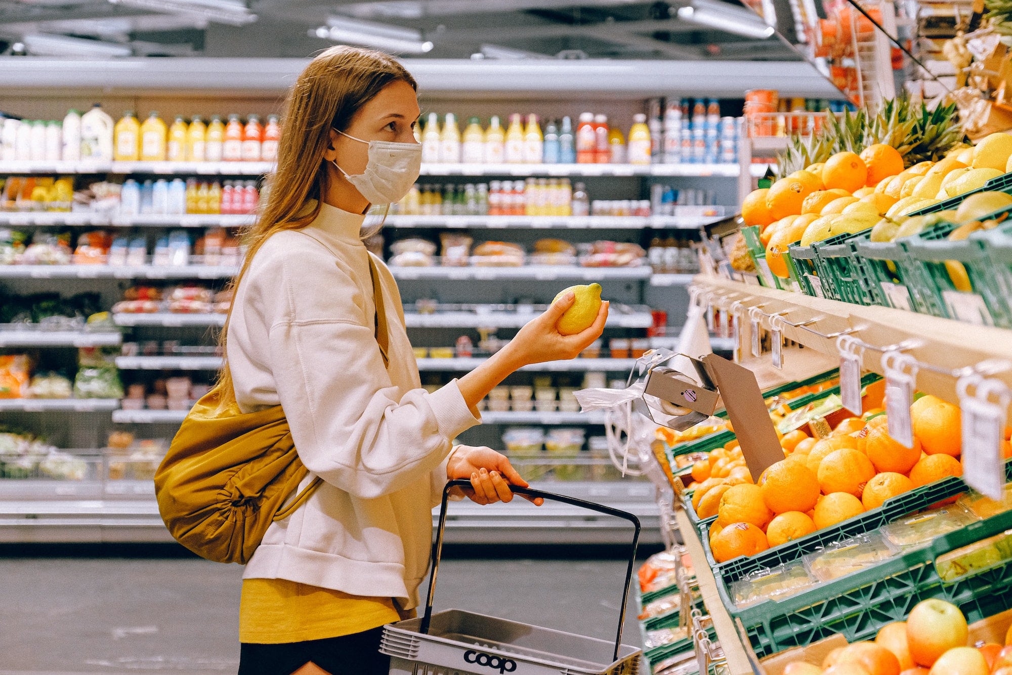 woman shopping in grocery store during coronavirus
