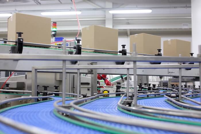 Overseas manufacturers: boxes on a conveyor belt at a factory