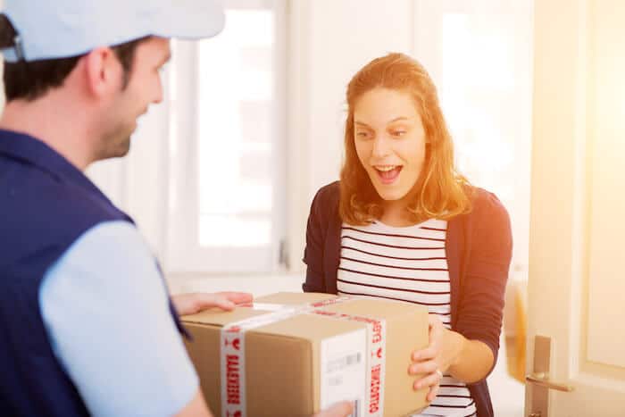 Lead time: delivery man handing a package to a customer