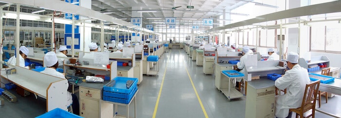 Panorama shot of people working in a factory