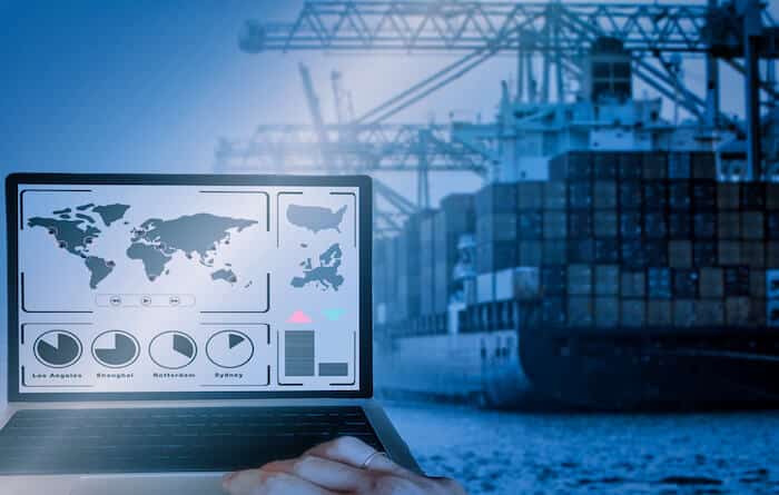 International freight shipping: cargo ship and a laptop with a world map on it