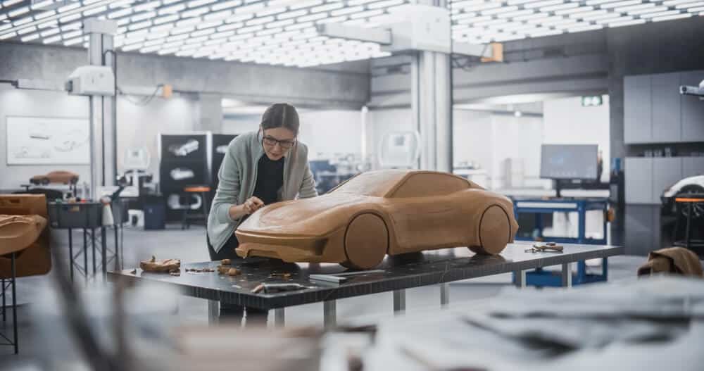 Women sculpting a prototype car to show how the car could be made and how it could look.