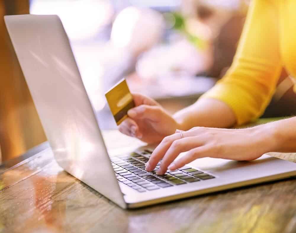 Women on computer purchasing something online with her credit card.