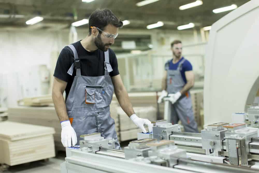 Two men working in a warehouse making a prototype for a client.