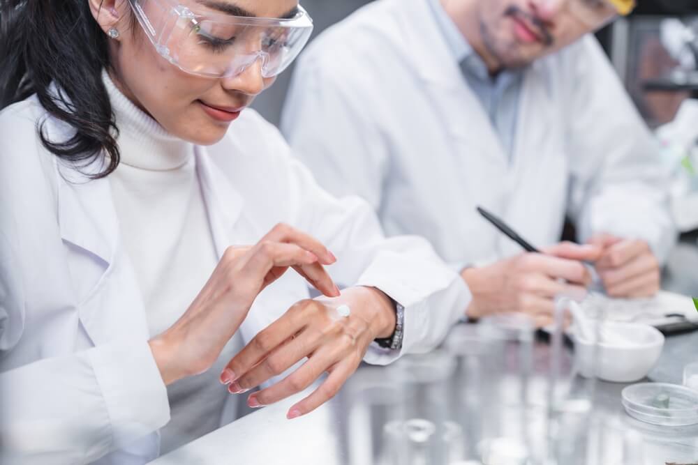 Scientist conducting an initial product test and sample on her hand.