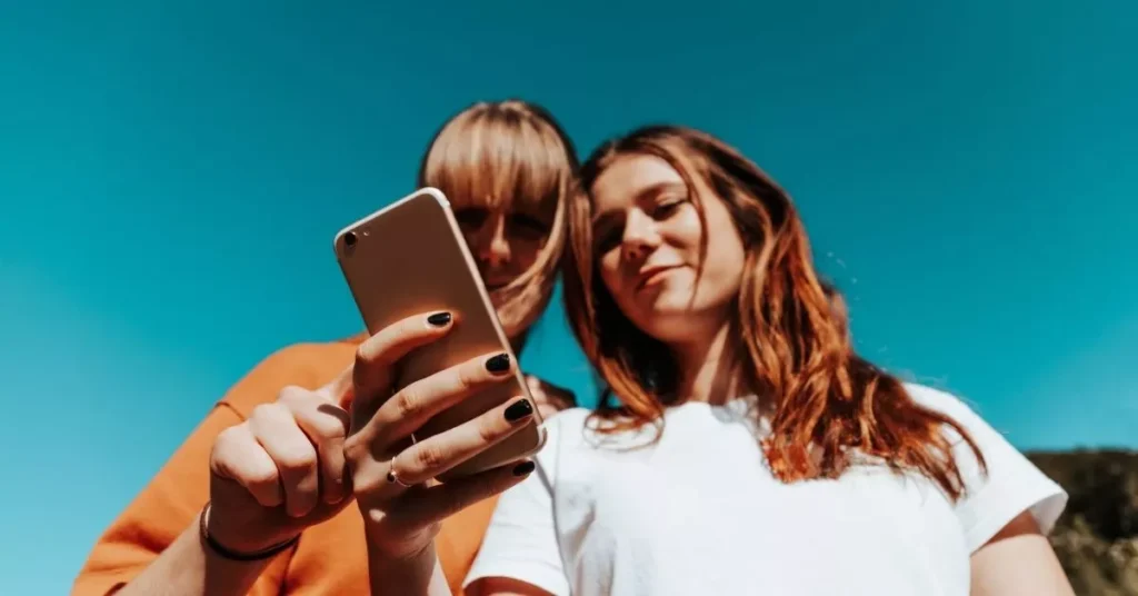 Two teens talking about their favorite influencer marketing a product on Instagram