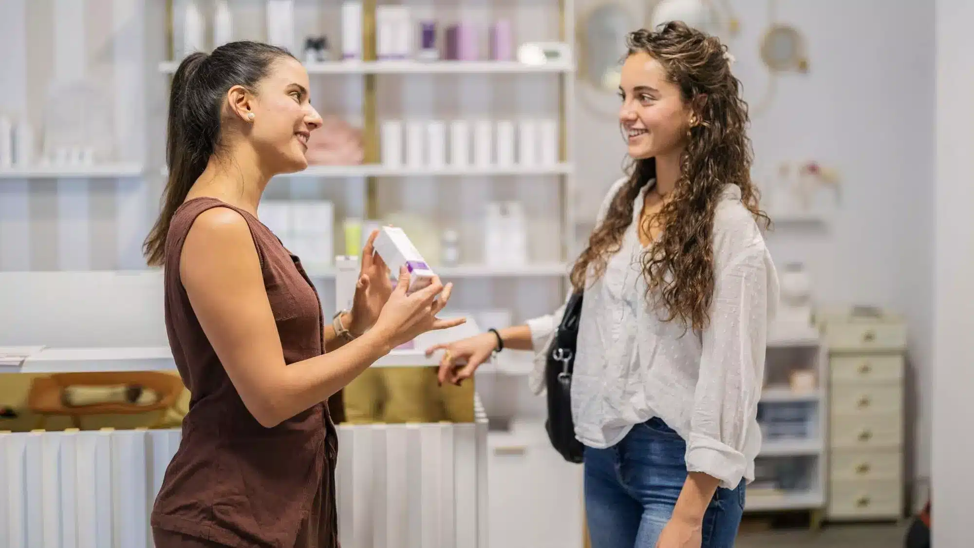 Products that sell demonstrated by a customer discussing a retail product with a store associate.