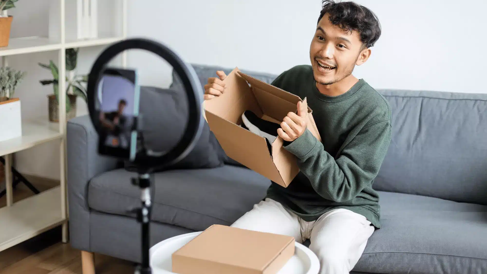 TikTok influencer marketing creator filming an unboxing video with a ring light to promote products on social media