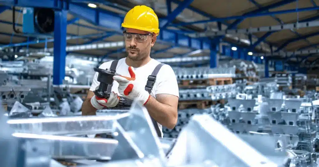 product development process in manufacturing facility with technician inspecting industrial parts