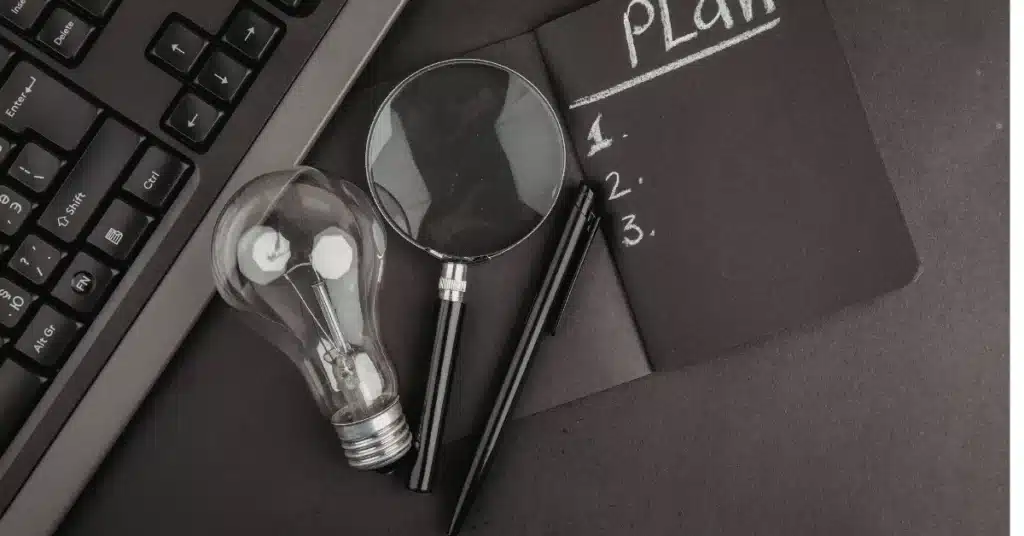 product development education planning workspace with notebook, lightbulb, and tools for learning product strategy