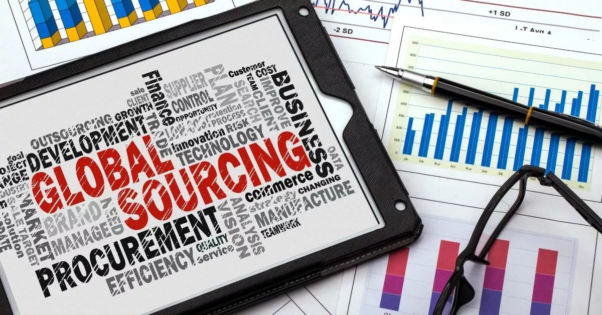 A tablet on top of charts and graphs highlights global sourcing and procurement, with data and reports spread out for analysis