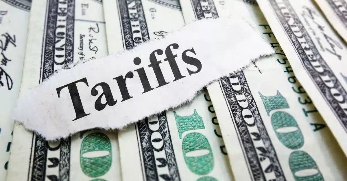 Close-up of U.S. currency with a "Tariffs" label, illustrating how changing trade policies and import duties affect manufacturing costs and sourcing decisions between China and Mexico.