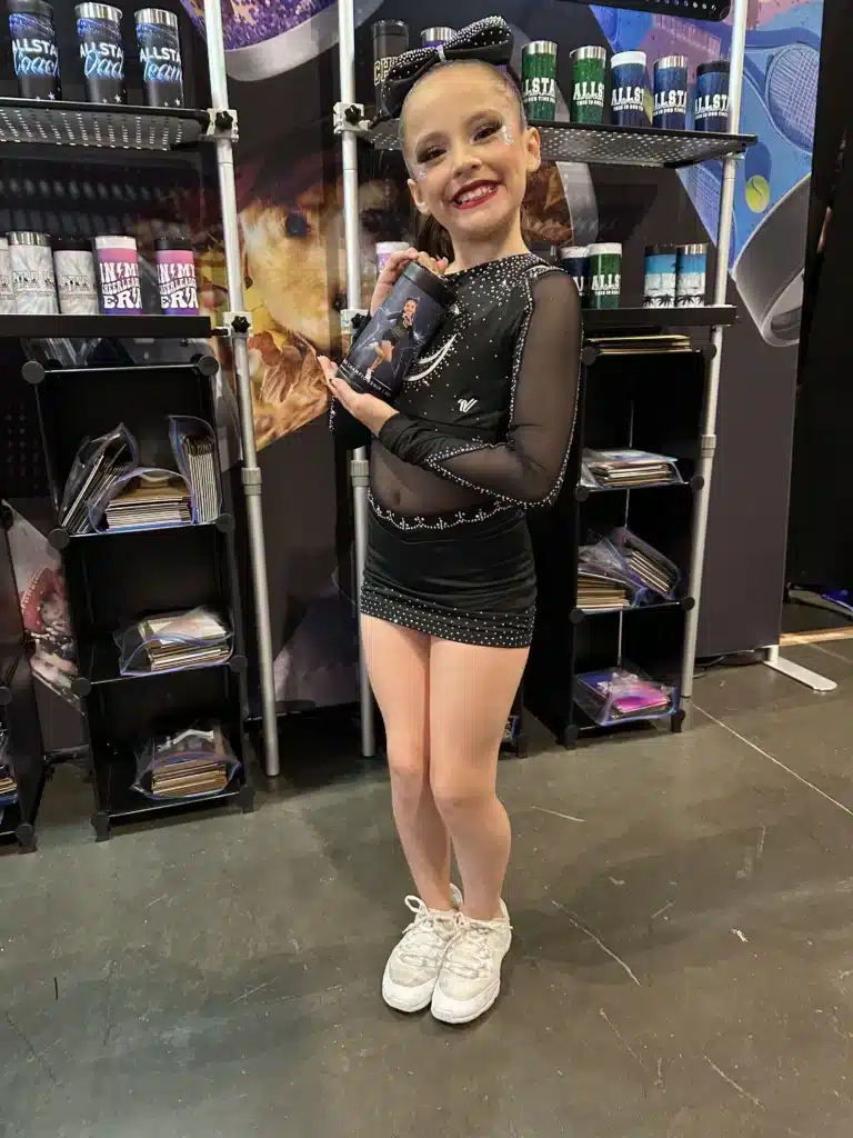 Young customer holding a custom Wrapware tumbler at the All Star World Cheerleading Championships in Orlando