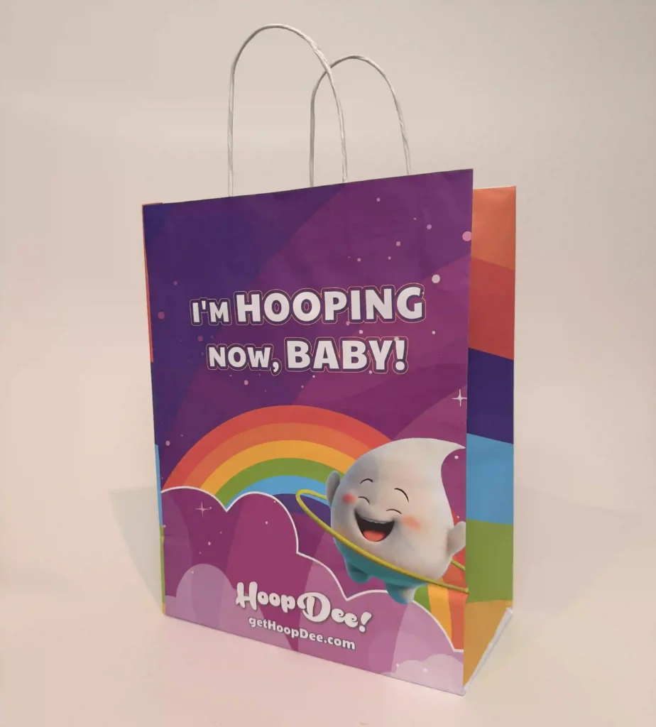 HoopDee branded shopping bag reading 'I'm Hooping Now, Baby!' used as walking advertising at expo events