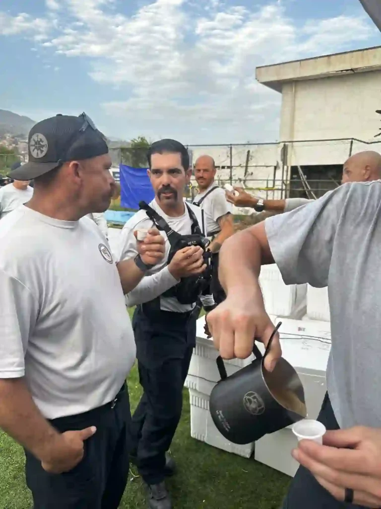 Miguel Ferrer pouring cafecito from a Search Grounds moka pot for fellow search-and-rescue responders on deployment