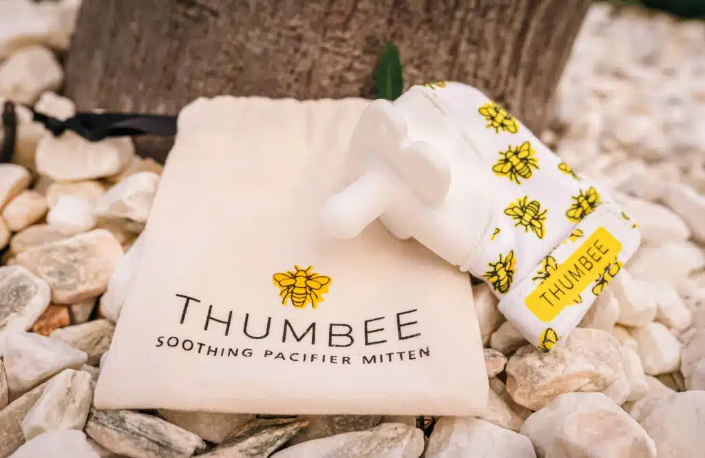 ThumBee soothing pacifier mitten with its bee-print fabric and canvas storage pouch